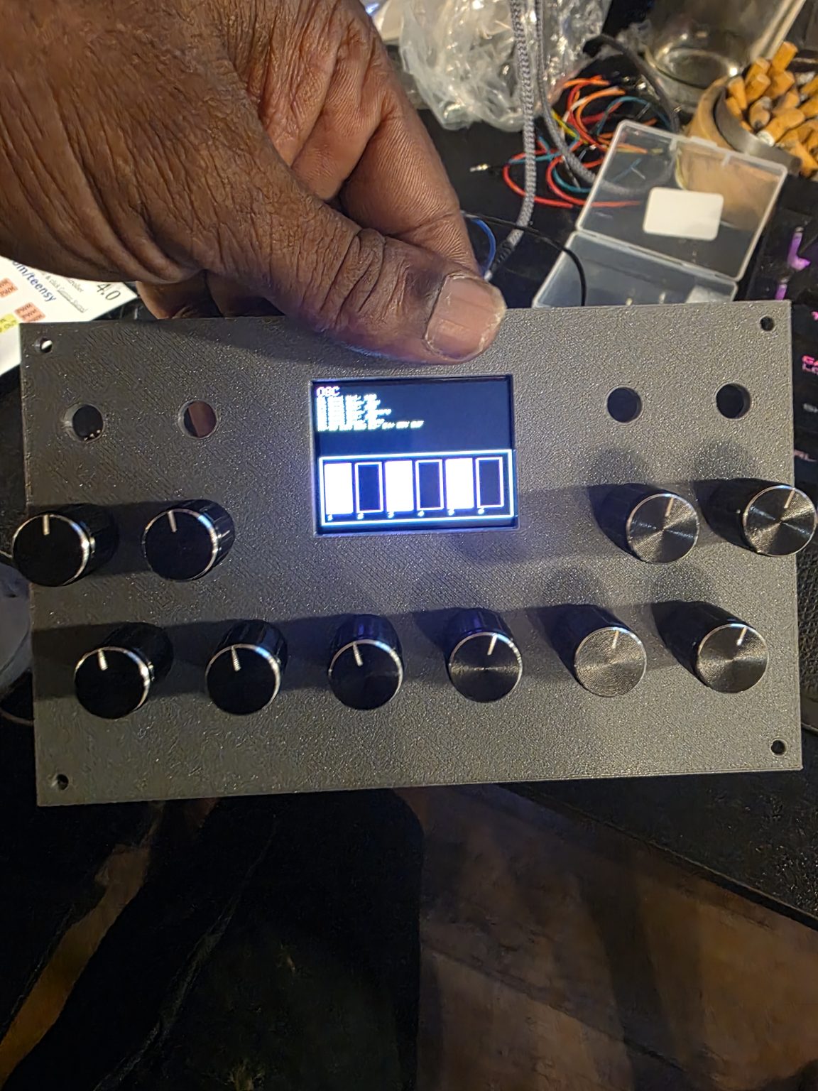 An LCD test-fitted into a 3D-printed faceplate.